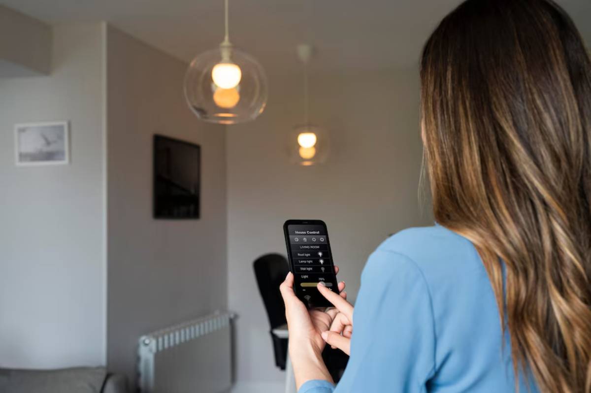 Woman using a smartphone to control smart lighting in a modern living room.