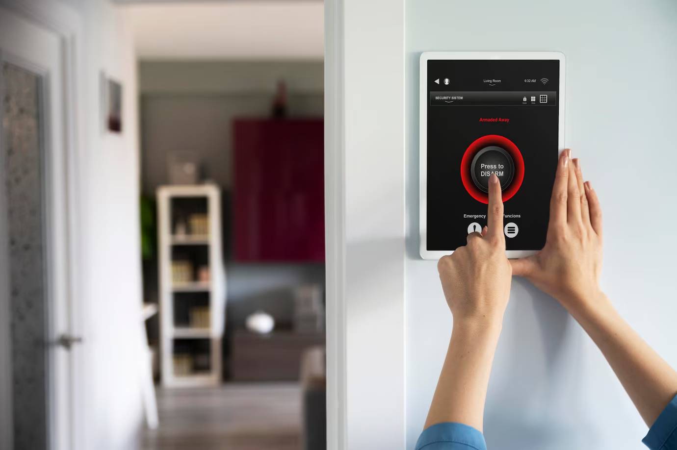 A person pressing a digital touchscreen panel labeled "Press to DISARM" to deactivate a home security system in a modern interior.